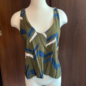 Green sleeveless shirt with blue and white pattern